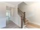 Staircase with wooden railing and white walls at 2105 Seneca Dr # 34, Raleigh, NC 27604