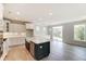 Open kitchen with white cabinets, large island, and stainless steel appliances at 2109 Seneca Dr # 35, Raleigh, NC 27604