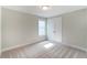 Bright bedroom with neutral walls, plush carpeting, and a window at 2109 Seneca Dr # 35, Raleigh, NC 27604