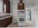 Galley style kitchen with dark cabinets and appliances at 810 E Edenton St, Raleigh, NC 27601
