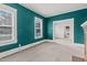 Spacious living room with teal walls, carpeting, and fireplace at 810 E Edenton St, Raleigh, NC 27601