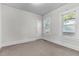 Bright bedroom with neutral carpeting and two windows at 810 E Edenton St, Raleigh, NC 27601
