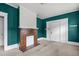 Living room with teal walls, fireplace and access to other rooms at 810 E Edenton St, Raleigh, NC 27601