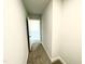 A long hallway with carpet and access to an upstairs loft at 333 Hopewell Branch Ct, Smithfield, NC 27577