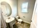 Clean bathroom with pedestal sink and tile flooring at 333 Hopewell Branch Ct, Smithfield, NC 27577