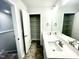 Double vanity bathroom with a linen closet and tile floor at 333 Hopewell Branch Ct, Smithfield, NC 27577