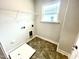 Laundry room with tile floor, shelving, and drain at 333 Hopewell Branch Ct, Smithfield, NC 27577