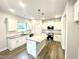Modern kitchen with white cabinets, an island, and stainless steel appliances at 333 Hopewell Branch Ct, Smithfield, NC 27577