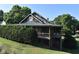 Rustic log cabin building with wrap-around porch and landscaping at 333 Hopewell Branch Ct, Smithfield, NC 27577