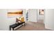 Bright hallway with bench and artwork leading to bedrooms at 385 Swift Creek Farm Ln, Clayton, NC 27520