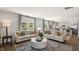 Open living room with hardwood floors and view into kitchen at 385 Swift Creek Farm Ln, Clayton, NC 27520