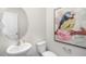 Small powder room with pedestal sink and oval mirror at 385 Swift Creek Farm Ln, Clayton, NC 27520