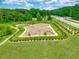 Aerial view of a fenced dog park with benches and trees at 120 Berry Mill Ln # 129, Raleigh, NC 27603