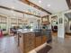 Open kitchen with a large island, stainless steel appliances, and exposed wooden beams at 548 Double N Rd, Pittsboro, NC 27312