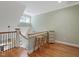 Upper hallway with hardwood floors and two wooden stools at 548 Double N Rd, Pittsboro, NC 27312