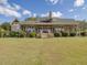 House exterior with wraparound porch and stone chimney at 548 Double N Rd, Pittsboro, NC 27312