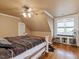 Spacious bedroom with a large bed, hardwood floors, and window seat at 548 Double N Rd, Pittsboro, NC 27312