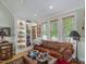 Comfortable living room with built-in shelving and large windows at 548 Double N Rd, Pittsboro, NC 27312