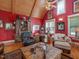 Rustic living room with red walls, wood beams, and comfortable seating at 548 Double N Rd, Pittsboro, NC 27312