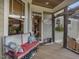 Inviting front porch with a wooden bench, potted plants, and room for seating at 548 Double N Rd, Pittsboro, NC 27312