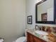 Powder room with marble vanity and wood accents at 548 Double N Rd, Pittsboro, NC 27312