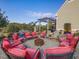 Patio with fire pit surrounded by red chairs and pergola at 548 Double N Rd, Pittsboro, NC 27312
