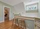 Upstairs hallway with two wooden stools and view into living area at 548 Double N Rd, Pittsboro, NC 27312