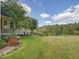 Landscaped backyard with spacious lawn and trees at 548 Double N Rd, Pittsboro, NC 27312