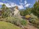 Landscaped yard with lush greenery and stone retaining wall at 548 Double N Rd, Pittsboro, NC 27312