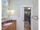 Bathroom features a marble vanity, a walk-in closet, and wood flooring at 548 Double N Rd, Pittsboro, NC 27312