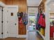 Charming entryway with wood walls, coat hooks, and view to back patio at 548 Double N Rd, Pittsboro, NC 27312