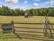 Horse in pasture with feeder and fence at 548 Double N Rd, Pittsboro, NC 27312