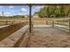 Sand riding arena with main house in background at 548 Double N Rd, Pittsboro, NC 27312