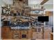 Modern kitchen with granite countertops, stainless steel appliances, and custom cabinetry at 548 Double N Rd, Pittsboro, NC 27312