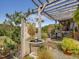 Rustic wooden fountain feature with lush landscaping and pergola backdrop at 548 Double N Rd, Pittsboro, NC 27312