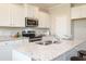 Spacious kitchen boasting white cabinets, granite countertops, and stainless steel appliances at 259 Johnson Ridge Way, Four Oaks, NC 27524