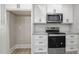 Stainless steel appliances and white shaker cabinets in kitchen at 45 S Harper Faith Way, Benson, NC 27504
