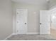 Bright bedroom with carpet, neutral walls and double doors at 45 S Harper Faith Way, Benson, NC 27504