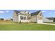 Beige house exterior with stone accents and landscaping at 45 S Harper Faith Way, Benson, NC 27504