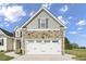 Two-car garage with stone and gray accents at 45 S Harper Faith Way, Benson, NC 27504