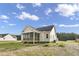 Beige house with a screened porch and a spacious backyard at 45 S Harper Faith Way, Benson, NC 27504