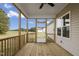 Relaxing screened porch with wooden deck and ceiling fan at 45 S Harper Faith Way, Benson, NC 27504