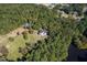 Aerial view of house on a large lot with a pond nearby at 488 Colvard Farms Rd, Durham, NC 27713