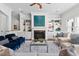 Spacious living area with a fireplace, built-in bookshelves, hardwood floors, and large windows at 488 Colvard Farms Rd, Durham, NC 27713