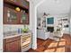 Wet bar with wine cooler, sink, and glass-front cabinetry at 488 Colvard Farms Rd, Durham, NC 27713