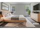 Virtually staged main bedroom with a large bed and dresser at 6849 Coventry Ridge Rd, Raleigh, NC 27616