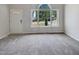 Bright living room with large window and carpet at 6849 Coventry Ridge Rd, Raleigh, NC 27616