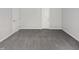 Spacious bedroom with grey carpet and large window at 6849 Coventry Ridge Rd, Raleigh, NC 27616