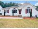 One-story house with white siding, red shutters, and landscaping at 6849 Coventry Ridge Rd, Raleigh, NC 27616