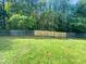 Large backyard with grassy area and wooden privacy fence at 6849 Coventry Ridge Rd, Raleigh, NC 27616